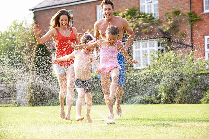 Michael's Well Drilling - Rock Hill Lancaster Charlotte | family running through sprinkler in residential neighborhood